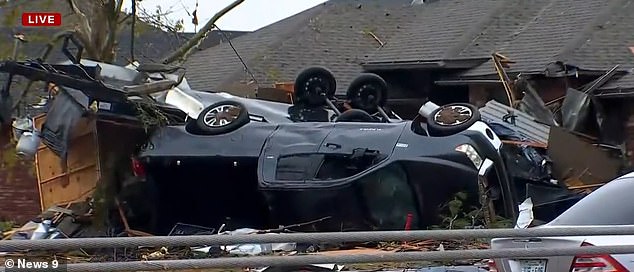 In the same area, a pickup truck was seen overturned in a person's yard.