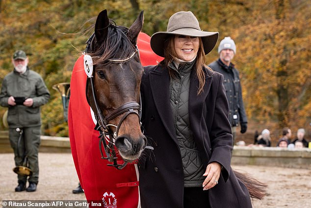 The mother of four couldn't hide her excitement, smiling as she petted the dark pony and posed for photos.