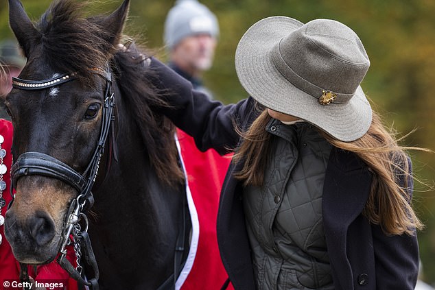 Queen Mary seemed to enjoy the horse's company as she petted the animal.