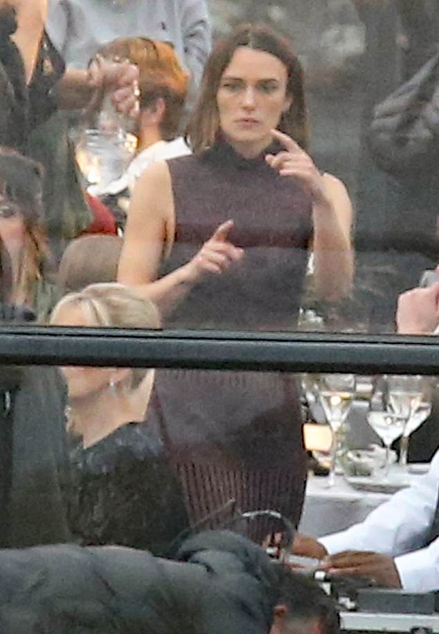 Keira looked sensational in a backless maroon dress for the scenes where the characters attended an elegant dinner.