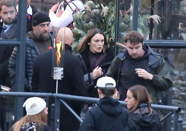 After filming, Keira bundled up in a puffer jacket.