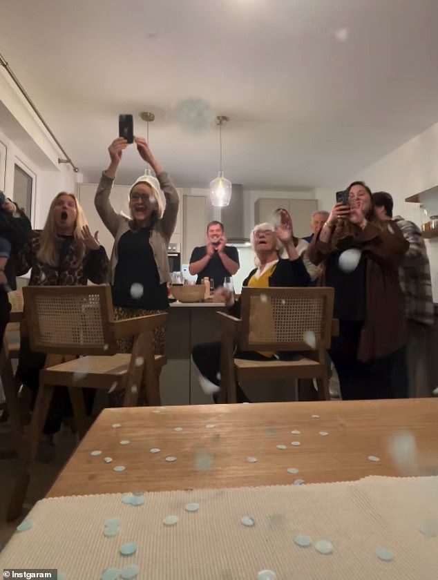 Then the family heard the news and cheered as they were doused with blue confetti.