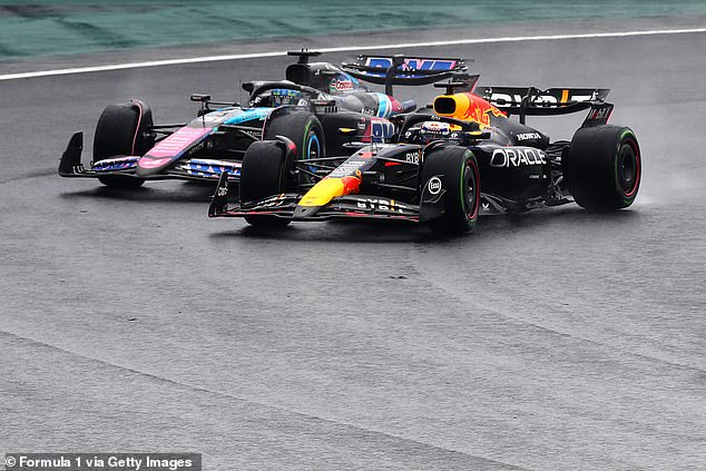 Dutchman Verstappen (right) pictured overtaking Ocon en route to victory in Brazil on Sunday.