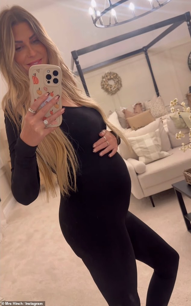 She donned a skin-tight black workout outfit and lovingly cradled her baby bump as she posed in front of her bedroom mirror.