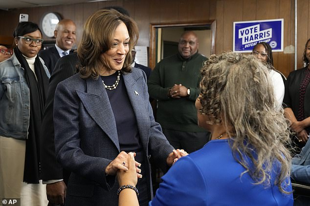 Democratic vice presidential nominee Kamala Harris (left) greets Martha Roland, mother of Elam barbershop owner Roland Elam Jr., as others look on before participating in a roundtable discussion with local leaders at the barbershop in Elam in Pontiac, Michigan, on Sunday. November 3, 2024