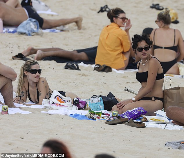 The friends appeared to avoid the water, opting to soak up some sun on the sand while taking a break from filming.