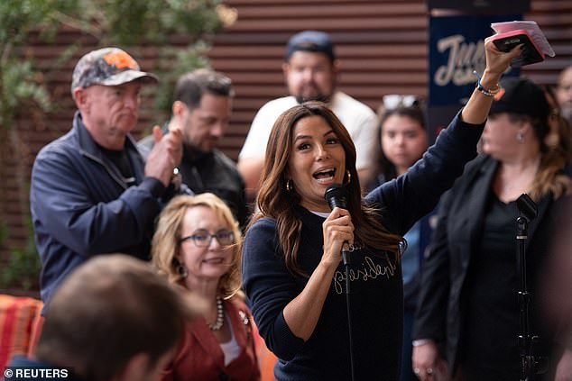 She brightened up the dark top with white skinny jeans and matching sneakers. Like Jessica, the actress and filmmaker wore hoop earrings, although she opted for a thicker gold pair.