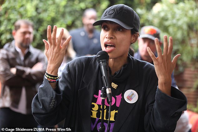 Rosario Dawson was a master of casual and modern style with her thick black sports coat, which she wore over a black shirt. She wore her hair in a ponytail and flattened under a black 'Love' baseball cap, and sported a stylish septum piercing.