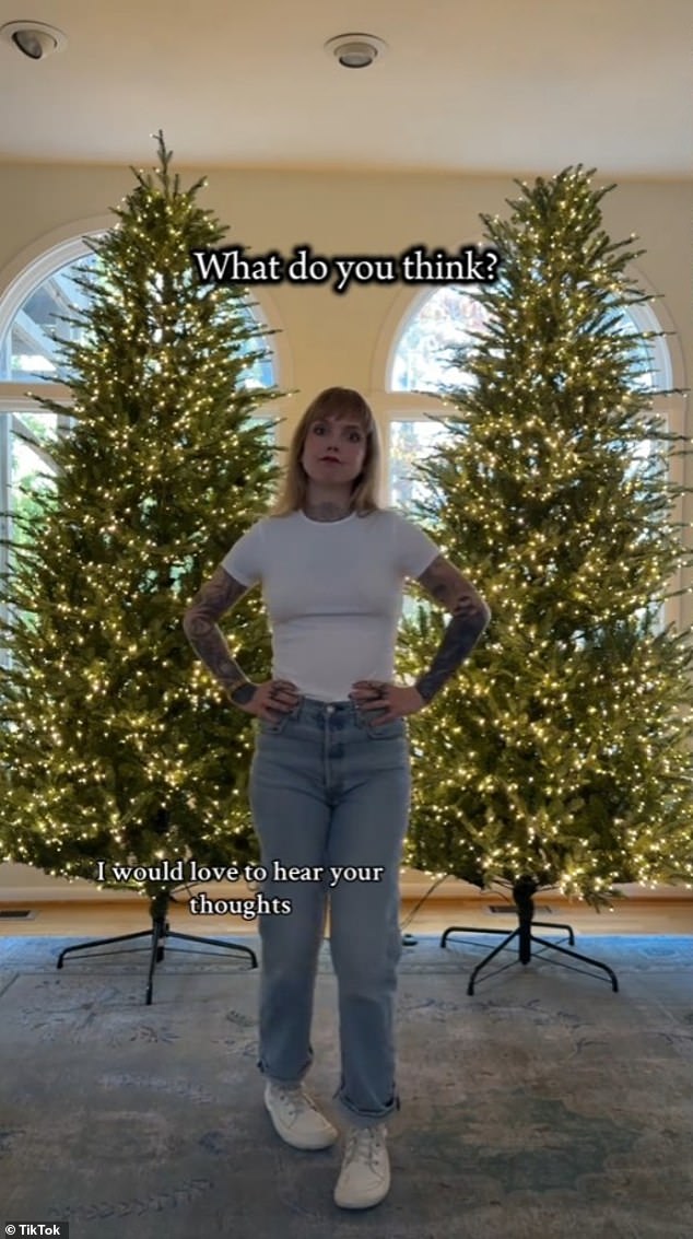 Sara Beth Clark poses in front of her two Home Depot Christmas trees