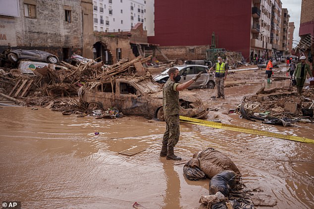 A soldier works in an area affected by floods in Catarroja, Spain