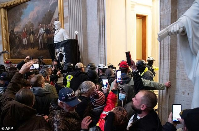 Supporters of Donald Trump clash with police inside the US Capitol during a protest aimed at stopping the transfer of power to Joe Biden, on January 6, 2021.