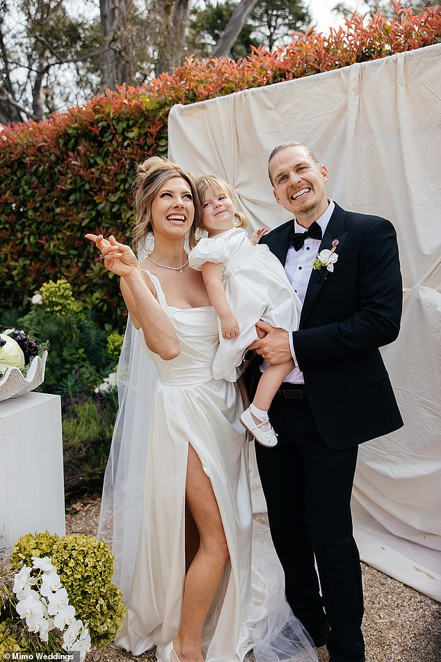 The wedding began with their adorable daughter, Remi, walking into her father's arms before bride Mimi made her dramatic entrance.