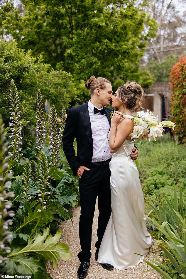 She held a bouquet of white lilies, adding a classic touch to her bridal ensemble.