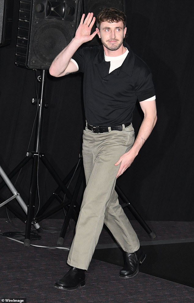 Paul cut a casual figure in a black T-shirt and chinos for his appearance.