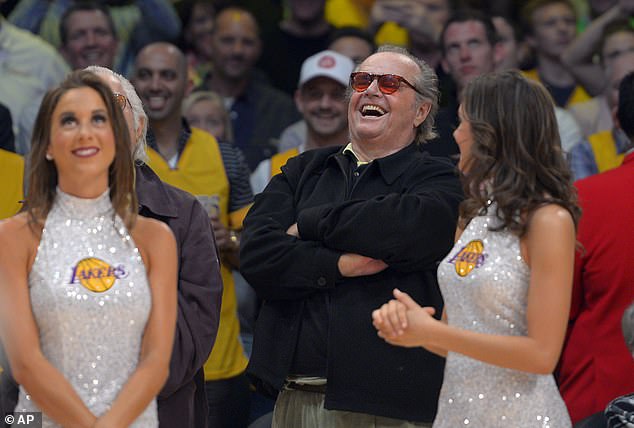 Nicholson laughs at former Los Angeles Lakers center Shaquille O'Neal as his jersey is retired during halftime of the Lakers' NBA basketball game against the Dallas Mavericks in 2013.