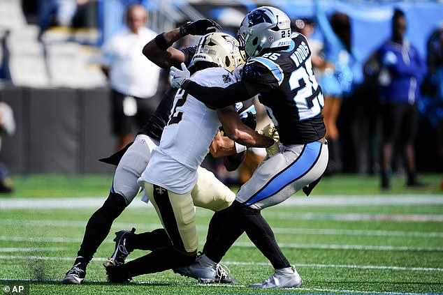 The receiver was caught between two defenders while trying to catch a pass.