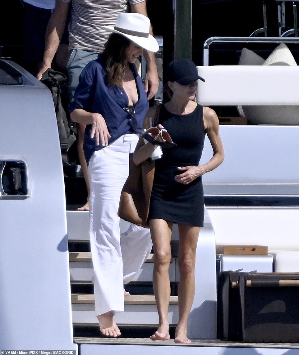 Cindy Crawford showed off her cleavage in a baggy blue shirt as she joined the Beckhams aboard their luxury boat.