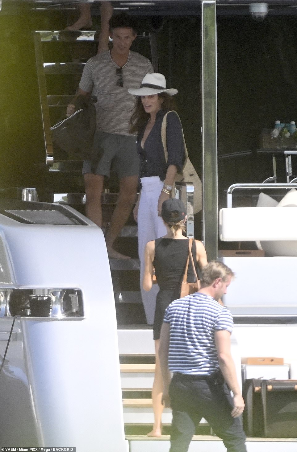 Friends Cindy and Victoria shared a smile as they prepared to leave the yacht and board a tender.