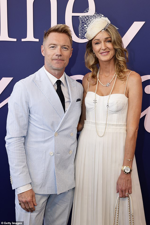 Ronan's appearance at the Melbourne Cup comes after he confirmed he has moved to Australia with his family (pictured with wife Storm).