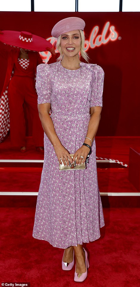 Television presenter and radio host Jacqueline Felgate wore an ankle-length printed mauve dress with a beret and mesh net.