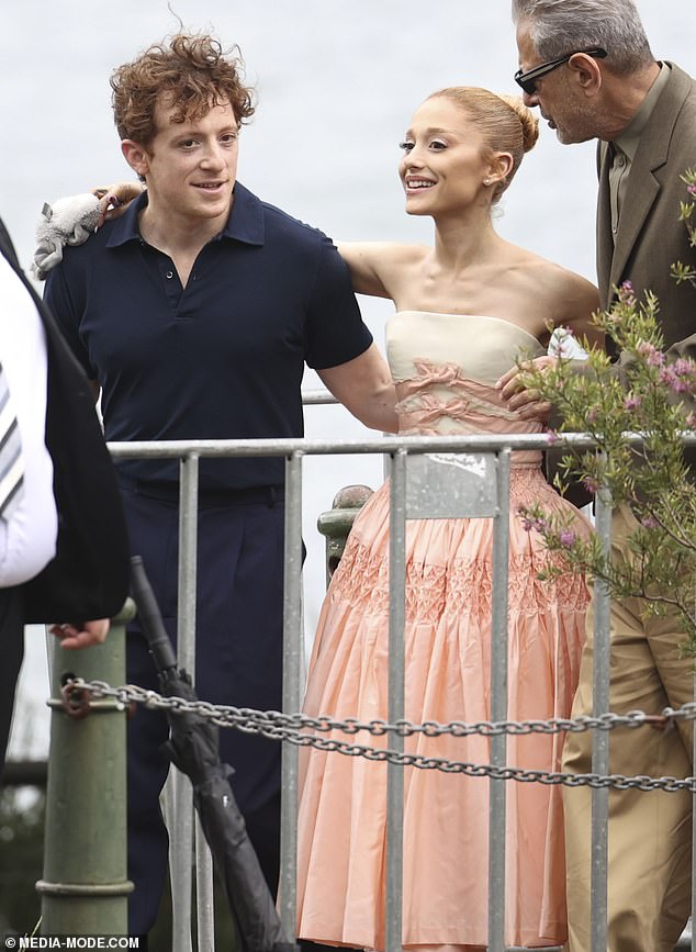 Ethan sported a relaxed look in a plain black dress shirt and matching pants, and seemed to be in great spirits as he embraced his gorgeous partner.