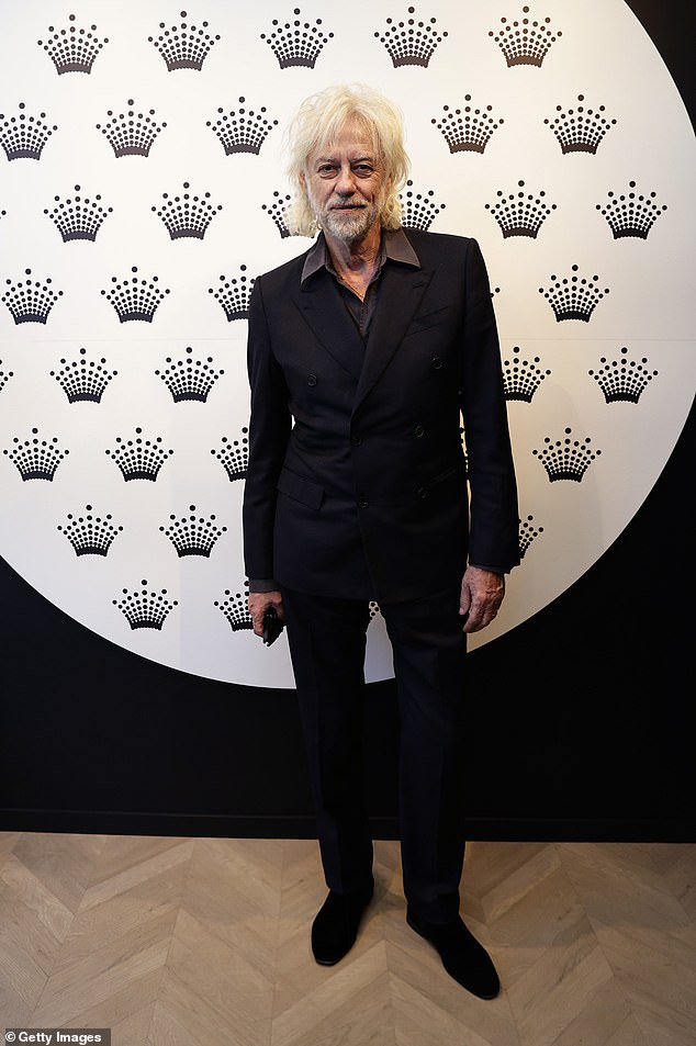 The iconic rock star wore a black suit paired with a purple shirt. He didn't wear a tie and opted for a casual but elegant look while working the event.