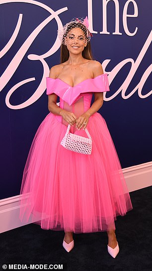 She paired the look with white heels, a purse and minimal jewelry.