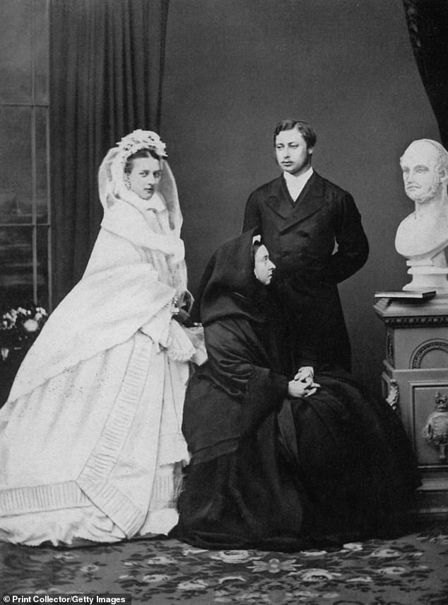 Queen Victoria with the future King Edward VII with his bride, Princess Alexandra of Denmark on their wedding day in 1863.