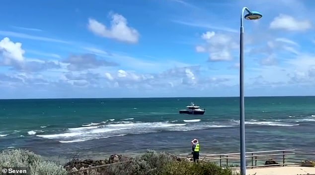 WA Police confirmed in a statement that the woman was a police officer who was off duty at the time (pictured, water police and a police officer at Trigg Beach in Perth on Tuesday).