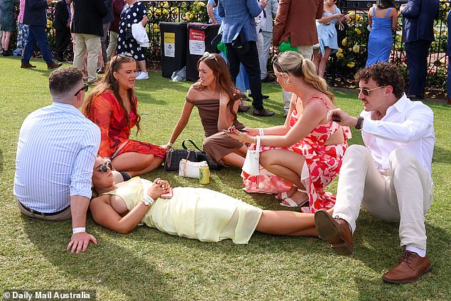 A woman was seen lying on her friend's lap while he sat chatting with his friends in a circle on the floor.