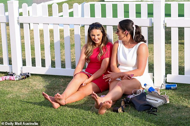 At the end of the day, the women took off their shoes and sat on the ground in the sun.