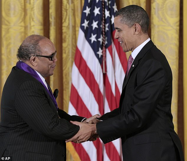 President Barack Obama presents a National Medal of Arts to Quincy Jones at the White House in March 2011.