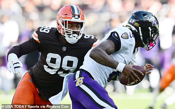 October 27, 2024; Cleveland, Ohio, USA; Cleveland Browns defensive end Za'Darius Smith (99) sacks Baltimore Ravens quarterback Lamar Jackson (8) during the second half at Huntington Bank Field. Mandatory Credit: Ken Blaze-Imagn Images