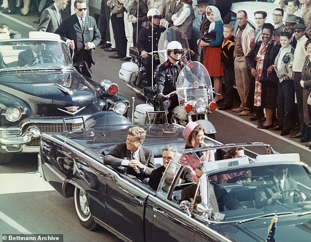 U.S. President John F. Kennedy, First Lady Jacqueline Kennedy, Texas Governor John Connally and others smile at the crowd lining their motorcade route in Dallas, Texas, on November 22, 1963. Minutes later, the president was assassinated as his car passed Dealey Plaza.