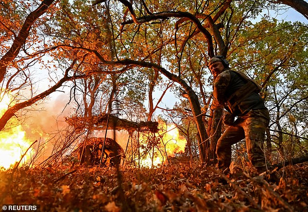 A Ukrainian service member of the Hyzhak (Predator) special police unit fires a D30 howitzer toward Russian troops, amid Russia's attack on Ukraine, near the border town of Toretsk, Ukraine, on October 25, 2024.