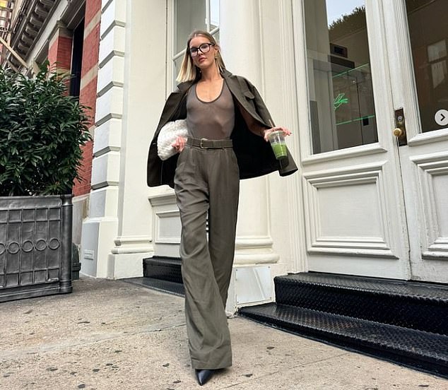 Corrigan looked like a natural beauty with light makeup and prescription glasses. The fashion magazine's cover girl was outside the Saint Laurent store in New York City.