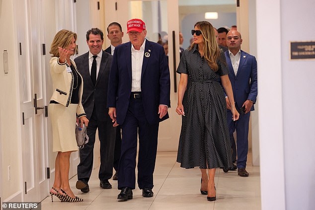 Donald Trump walks with Melania after voting at the Mandel Recreation Center in Palm Beach