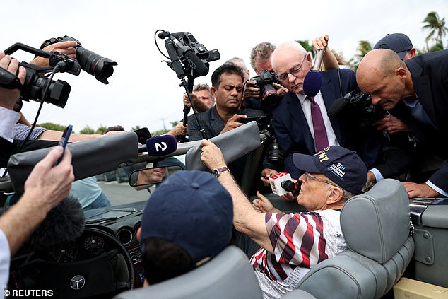 Rudy Giuliani was seen in a car outside the Palm Beach voting center where Trump voted.