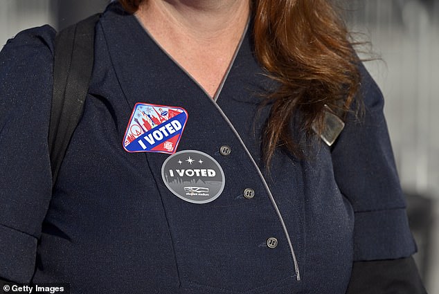 A Nevada resident wears a sticker that says 