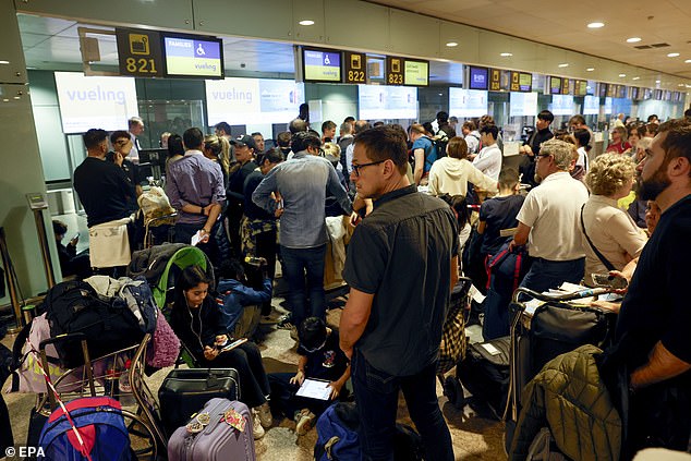 Passengers wait at El Prat airport after several flights were canceled due to heavy rain, in Barcelona, ​​Catalonia.