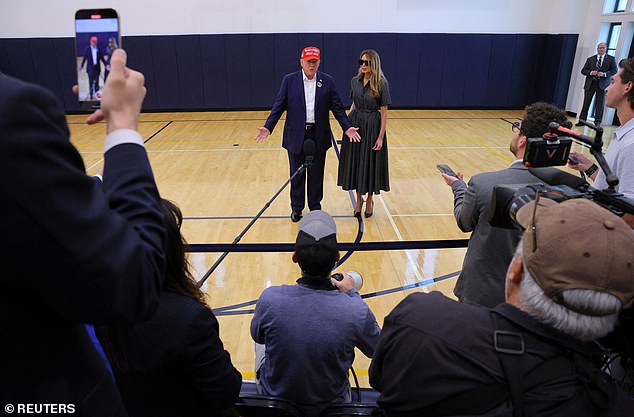 The press lined up to ask Trump questions after his vote at a local polling station.