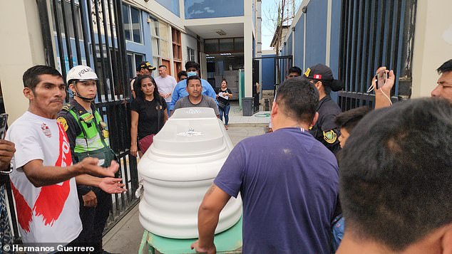 A coffin containing the body of the late Peruvian singer is taken to a local funeral home.