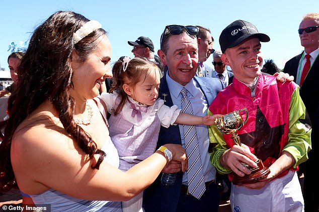 Dolan (pictured with his wife, daughter and father after winning the Cup) moved to Australia in 2016 looking for a fresh start due to a lack of opportunities as an apprentice jockey in Ireland.