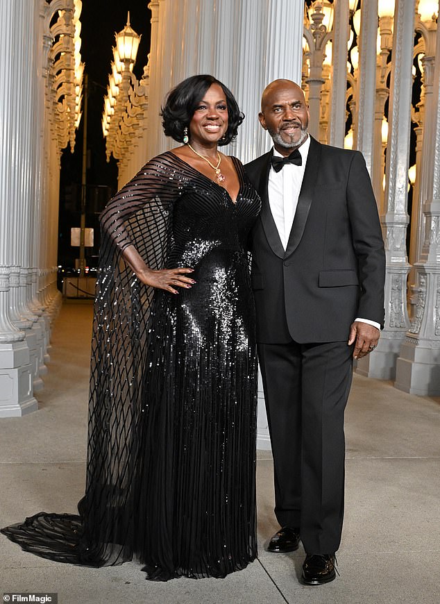 At the event with her husband Julius Tennon, Davis donned a black sequin Gucci dress with long sleeves and a cape.