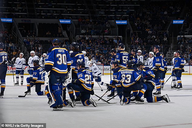 Players knelt on the ice as doctors tended to Holloway before he was taken to the hospital.