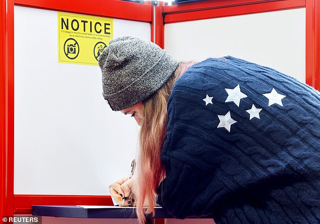 A woman votes during the 2024 US presidential election on Election Day, in Arden, North Carolina.