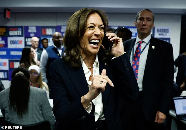 Democratic presidential candidate US Vice President Kamala Harris reacts while speaking on the phone at the Democratic National Committee (DNC) headquarters during the 2024 US presidential election on Election Day in Washington.