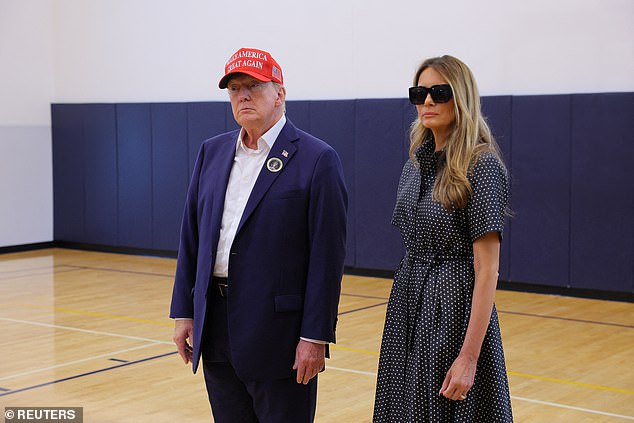 Republican presidential candidate and former US President Donald Trump, accompanied by former US First Lady Melania Trump, speaks to reporters after voting at the Mandel Recreation Center on Election Day in Palm Beach, Florida.