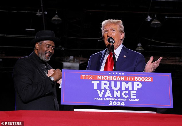 Republican presidential candidate and former US president Donald Trump speaks on stage alongside former boxer Thomas. "hitman" Hearns, during a rally at Huntington Place in Detroit, Michigan, USA, October 18, 2024. Trump saw pre-election margins that improved his 2020 numbers among Black and Hispanic voters