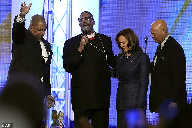 Bishop John Drew Sheard, center left, leads a congregation in a prayer for Vice President Democratic presidential candidate Kamala Harris, center right, during a church service at Greater Emmanuel Institutional Church of God in Christ, Sunday, Nov. 3, 2024, in Detroit. . Harris hoped to increase black turnout in the final days of the race.